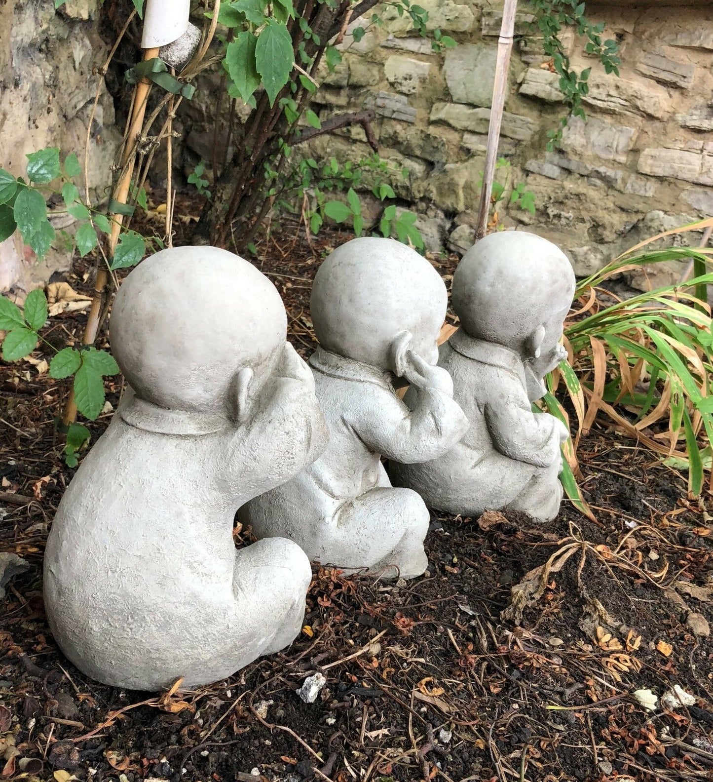 Rear view of stone Baby Monk Ornaments trio, showcasing sculpted robes and smooth finish for outdoor garden decor.
