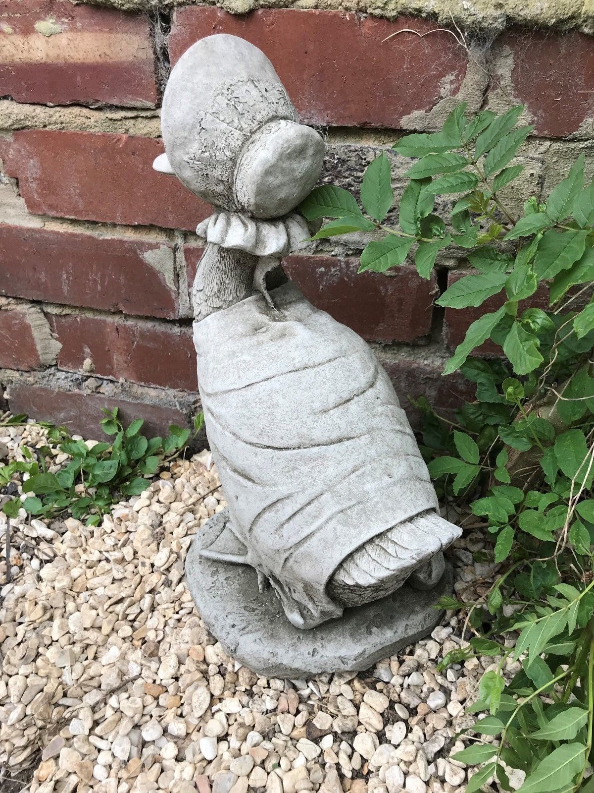 Rear view of Jemima Duck stone statue showing bonnet and shawl details. Designed for outdoor garden or patio display.