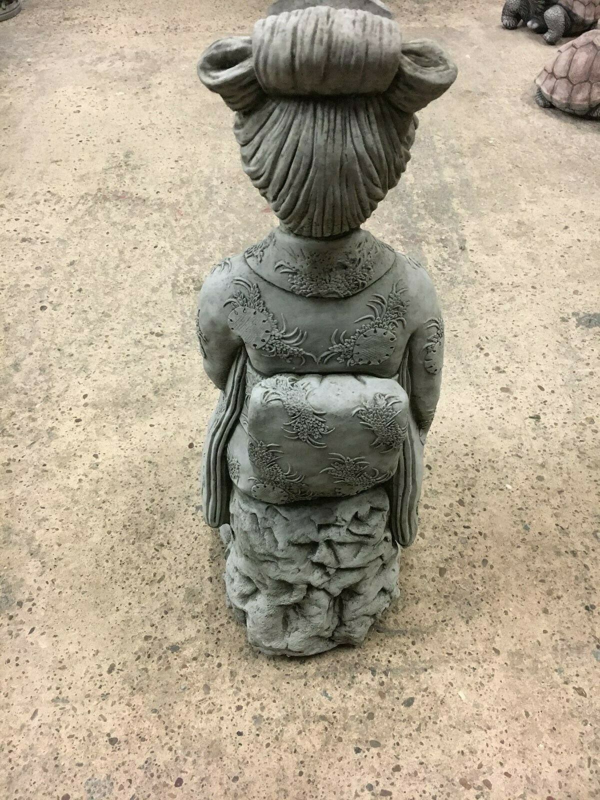 Rear view of Stone Kneeling Geisha Lady Statue showing kimono back and hair design, suitable for tranquil garden spaces.