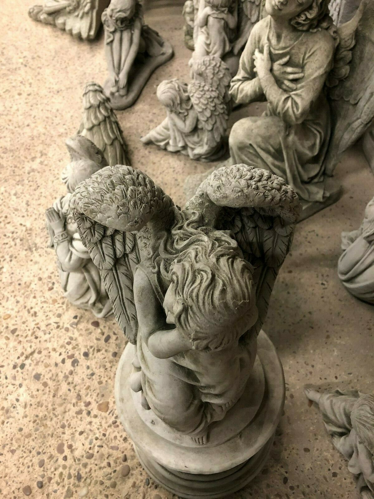Overhead view of Stone Angel Garden Statue - On Ball Plinth, emphasizing sculpted wings and serene pose in durable limestone.