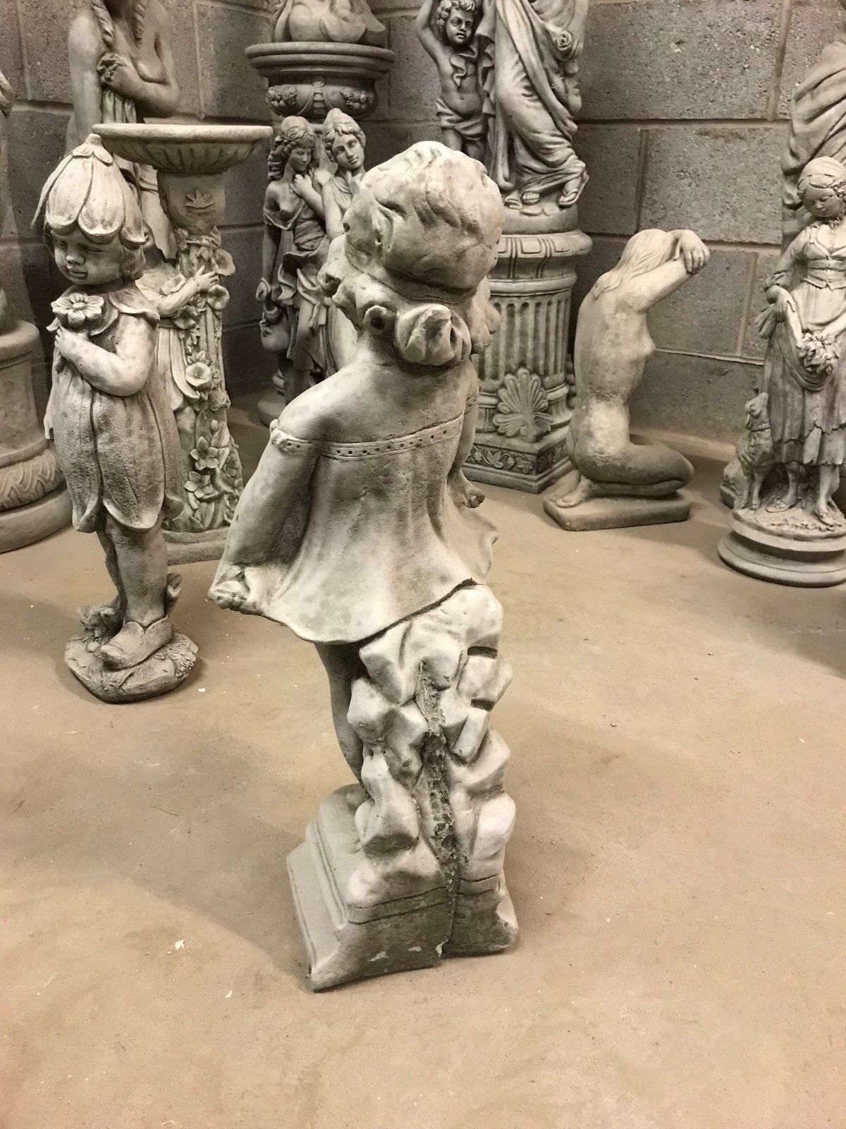 Angled rear view of Shy Girl Statue showing sculpted stone support and dress detail, perfect for classic garden aesthetics.