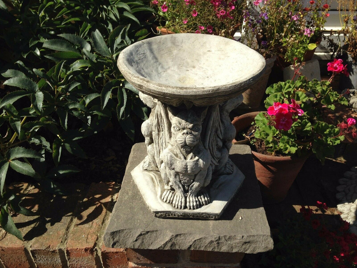 Stone Gargoyle Design Bird Bath with detailed grotesque figures supporting a wide basin, ideal for garden decor and bird feeding.