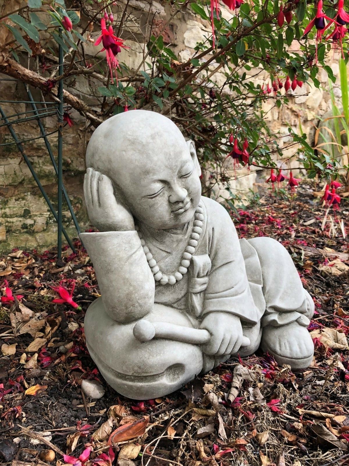 Stunning Stone Resting Monk Sculpture Garden Ornament showing a meditative child monk, handmade in antique grey stone for lasting garden charm.
