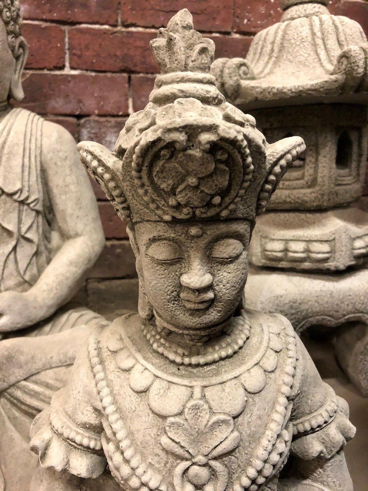 Serene Buddha Statue Garden - Meditating Stone | Peaceful Decor. Top view of Buddha statue’s crown and facial features, ideal for zen garden or patio decor.