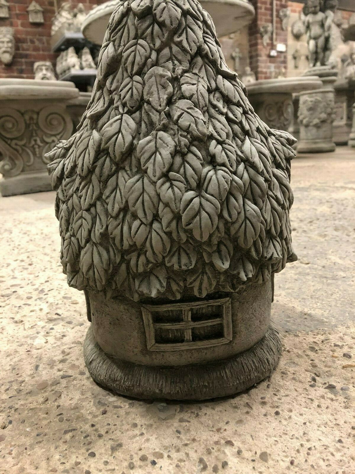 Rear view of Stone Ivy Cottage Ornament with textured stone finish and rectangular window, perfect for outdoor garden sculpture display.