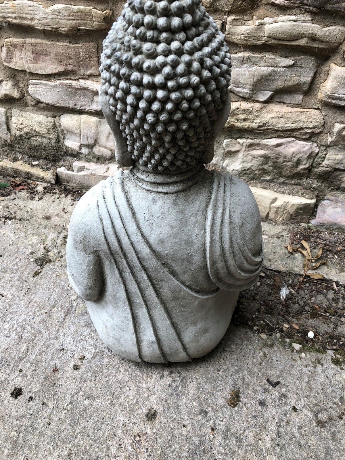 Rear view of Stone Buddha Statue showing robe detail and textured hair, designed for 360° visual appeal in garden ornament displays.