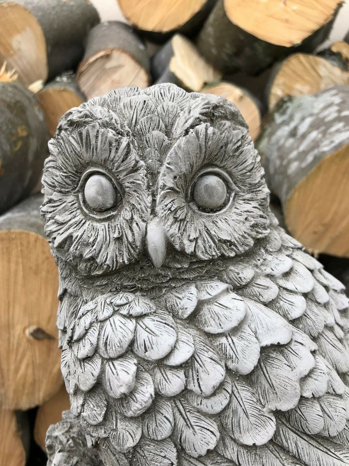 Detailed view of mother owl's face on limestone garden ornament. Features realistic feather texture and antique stone finish.