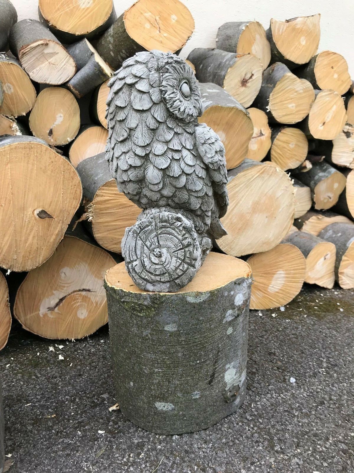 Side profile of mother owl garden statue on log. Made from fine limestone, ideal for outdoor animal-themed decor.