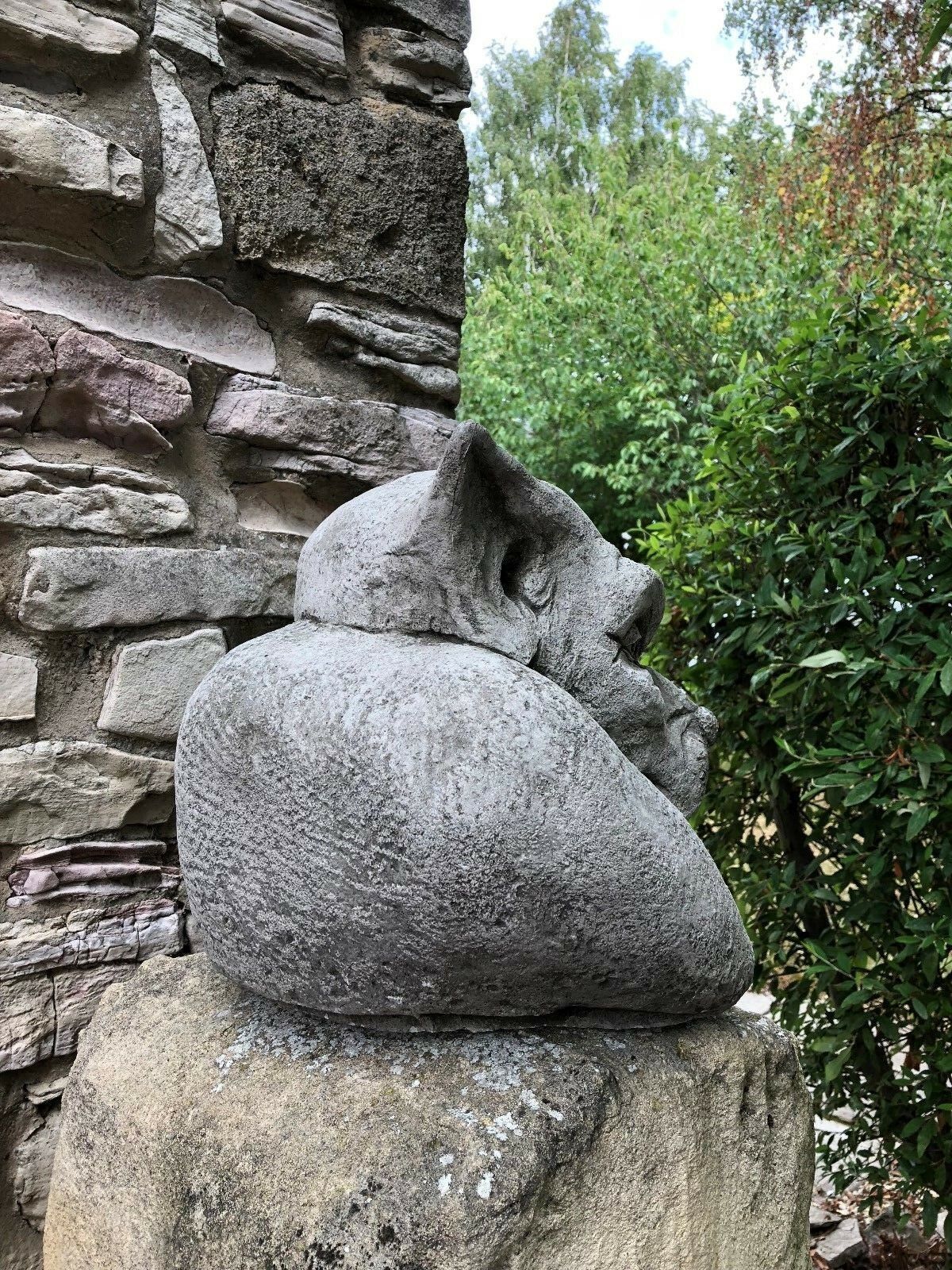 Profile view of Gargoyle Dog Finial - Stone Garden Ornament highlighting its textured stone surface and sculpted detail.