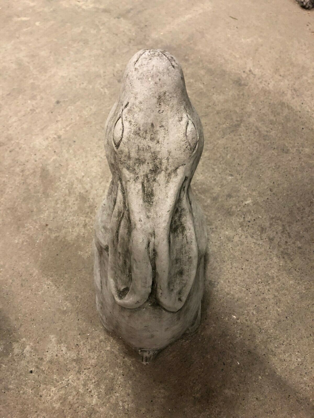 Overhead view of the Moongazing Hare Stone Statue emphasizing its sculpted ears and antique grey finish, suitable for outdoor garden settings.