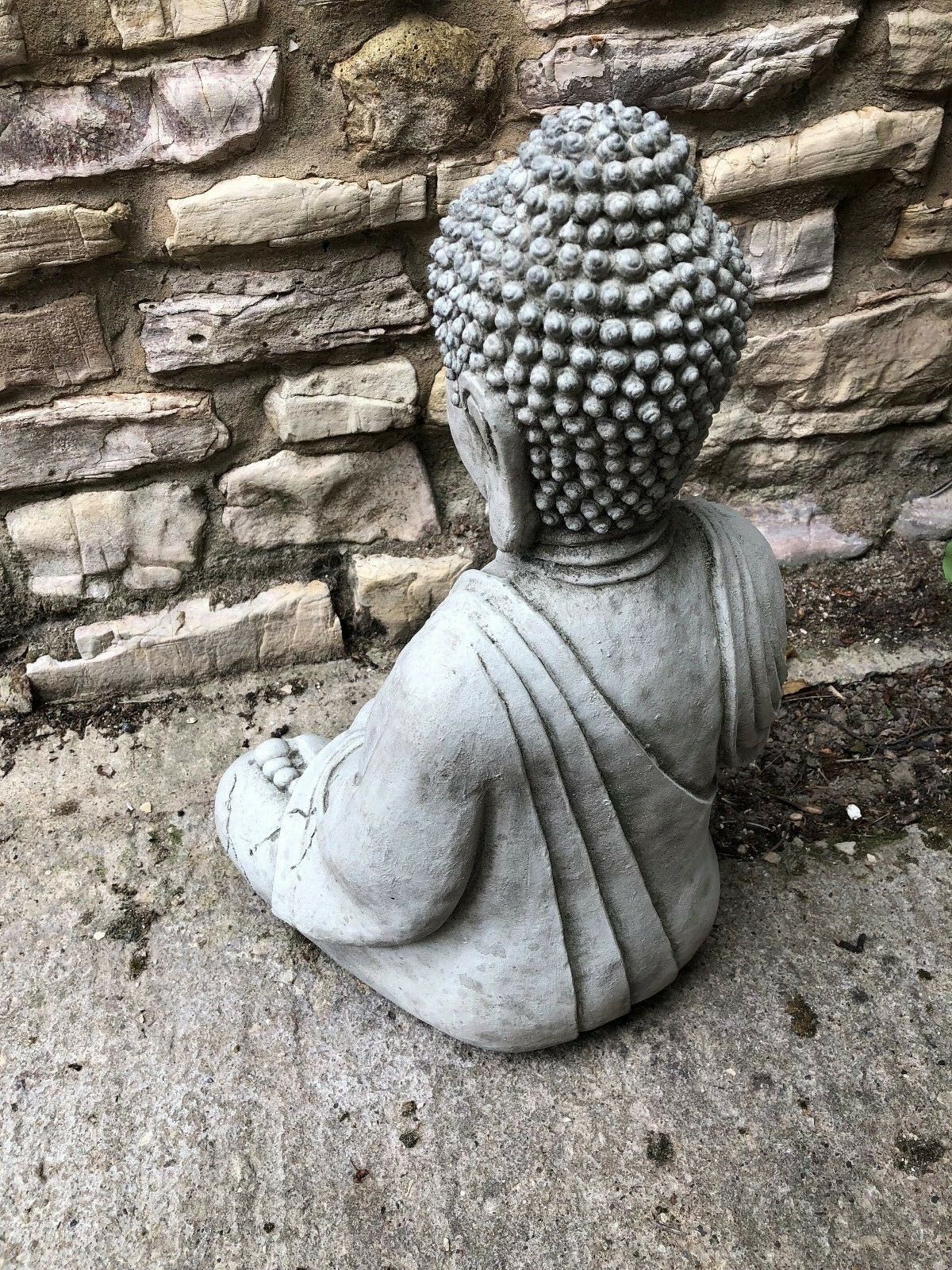 Back angled view of Meditating Buddha Statue, highlighting solid stone construction and aged finish for durable outdoor garden decor.