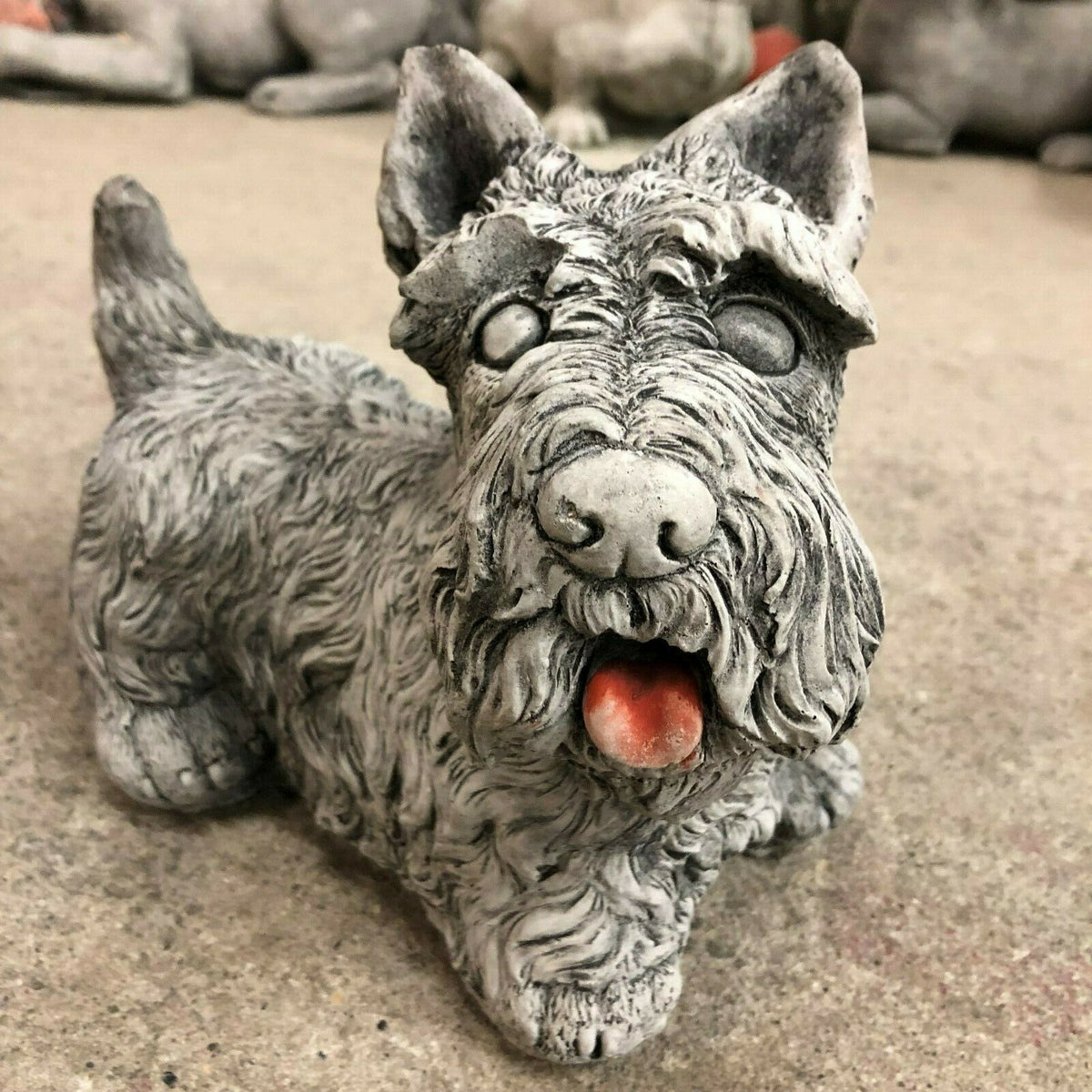 Scottish Terrier garden statue in antique grey stone finish with detailed fur texture and red tongue, ideal for outdoor lawn decor.