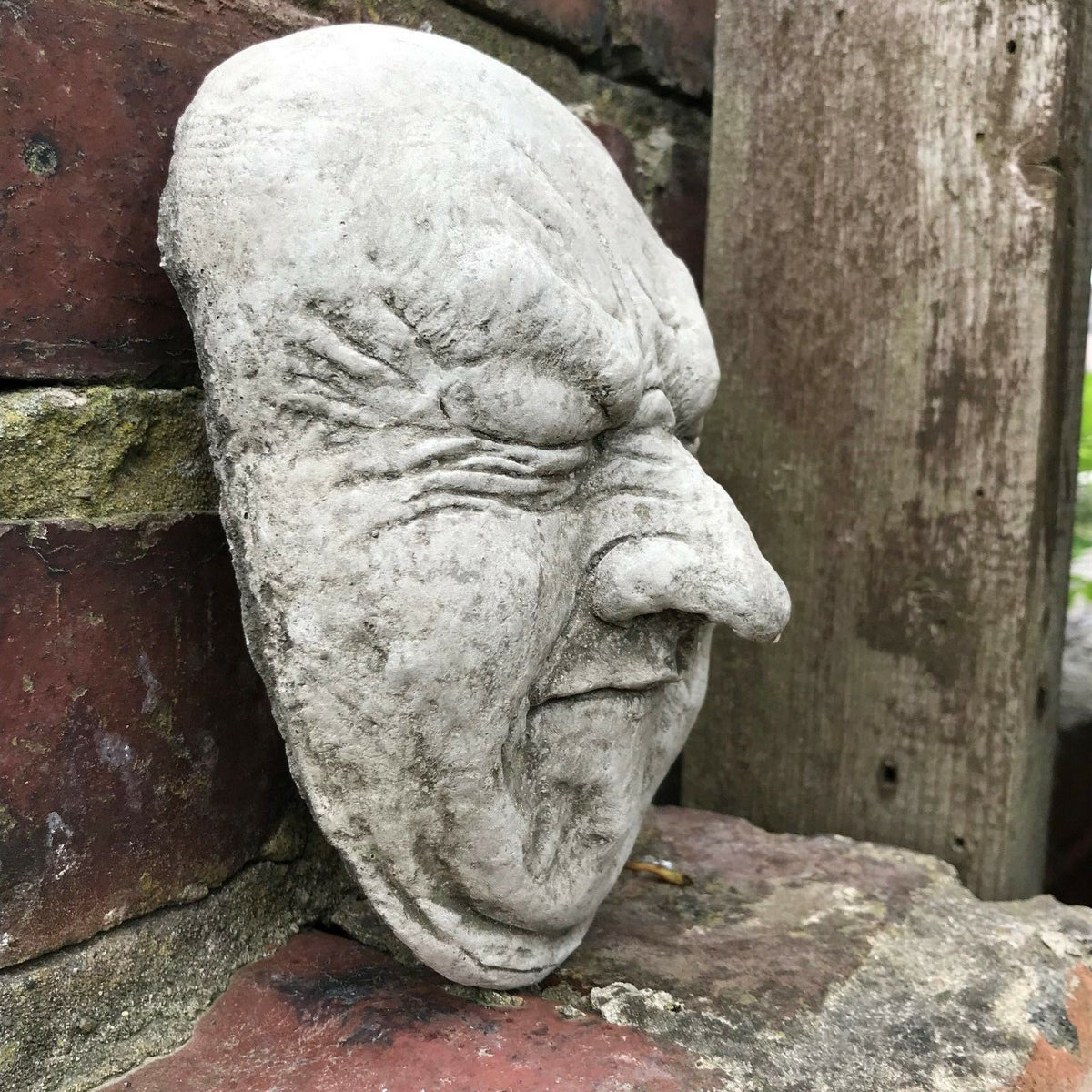 Side view of Funny Stone Garden Plaque - Garden Wall Plaque showing detailed facial expression and solid limestone build for garden walls.