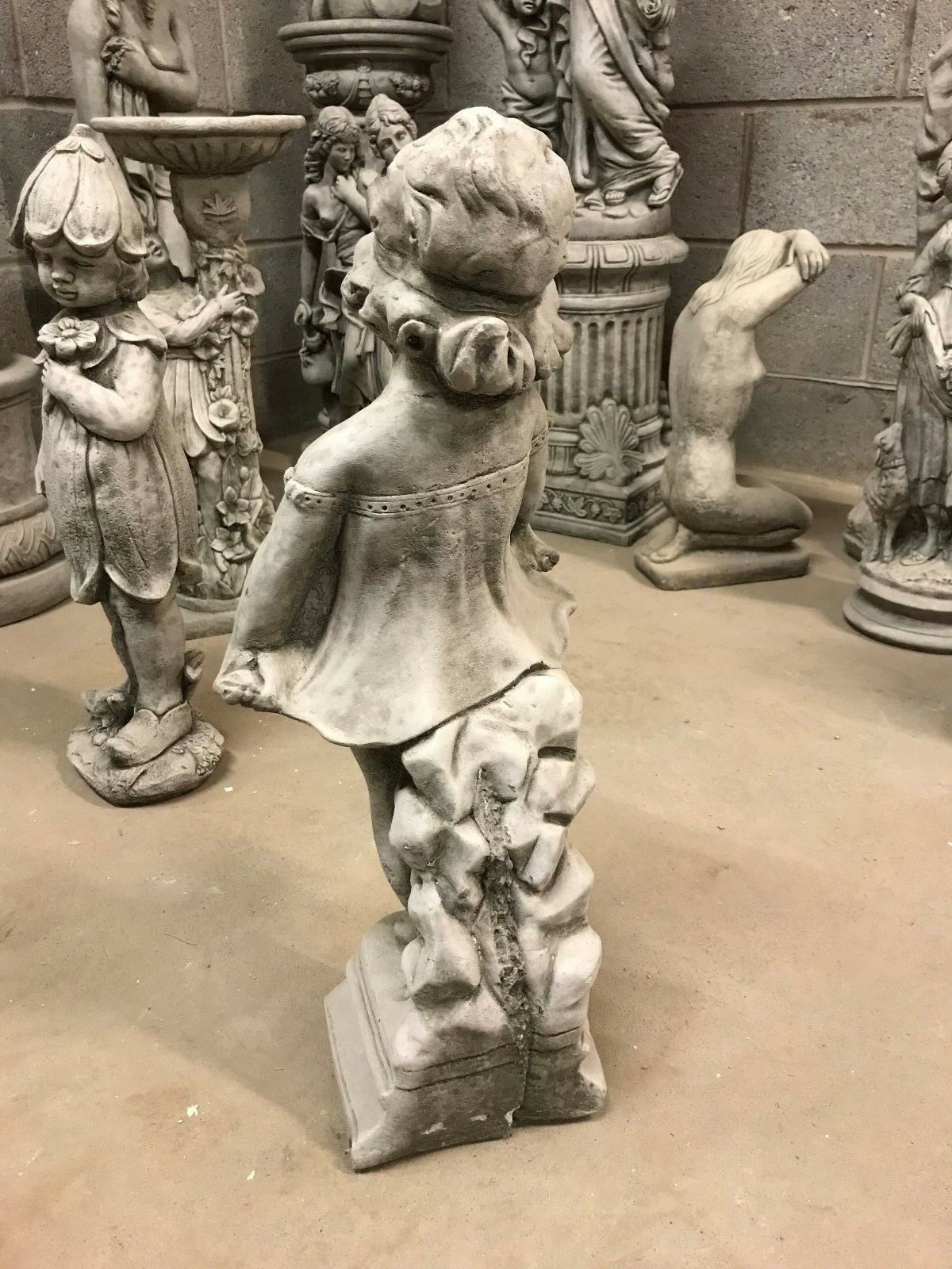 Shy Girl Stone Garden Sculpture from rear side angle, emphasizing handcrafted limestone texture and ornamental design.