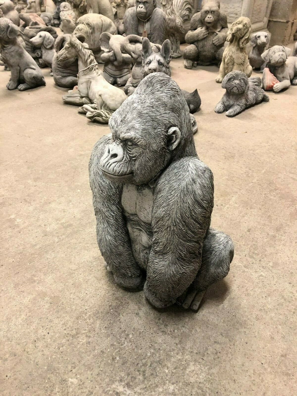 Weather-resistant Stone Silverback Gorilla Statue in seated pose, side angle highlighting intricate craftsmanship for outdoor garden use.