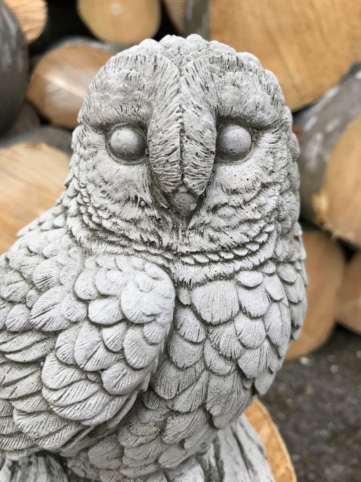 Close-up of baby owl limestone ornament with fine feather texture. Ideal for pairing with mother owl in garden settings.