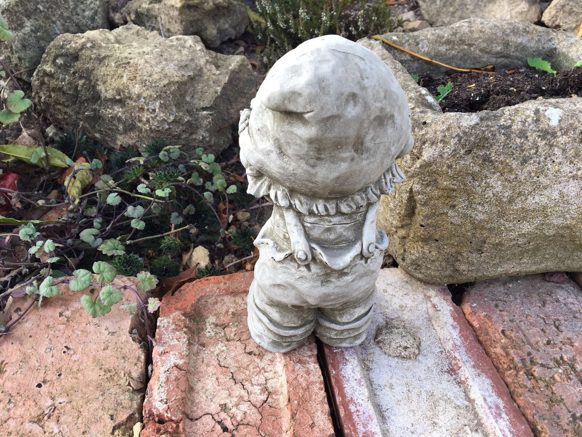 Rear view of the Stone Boy Garden Ornament in Dungarees showing detailed craftsmanship. A durable and decorative garden sculpture.