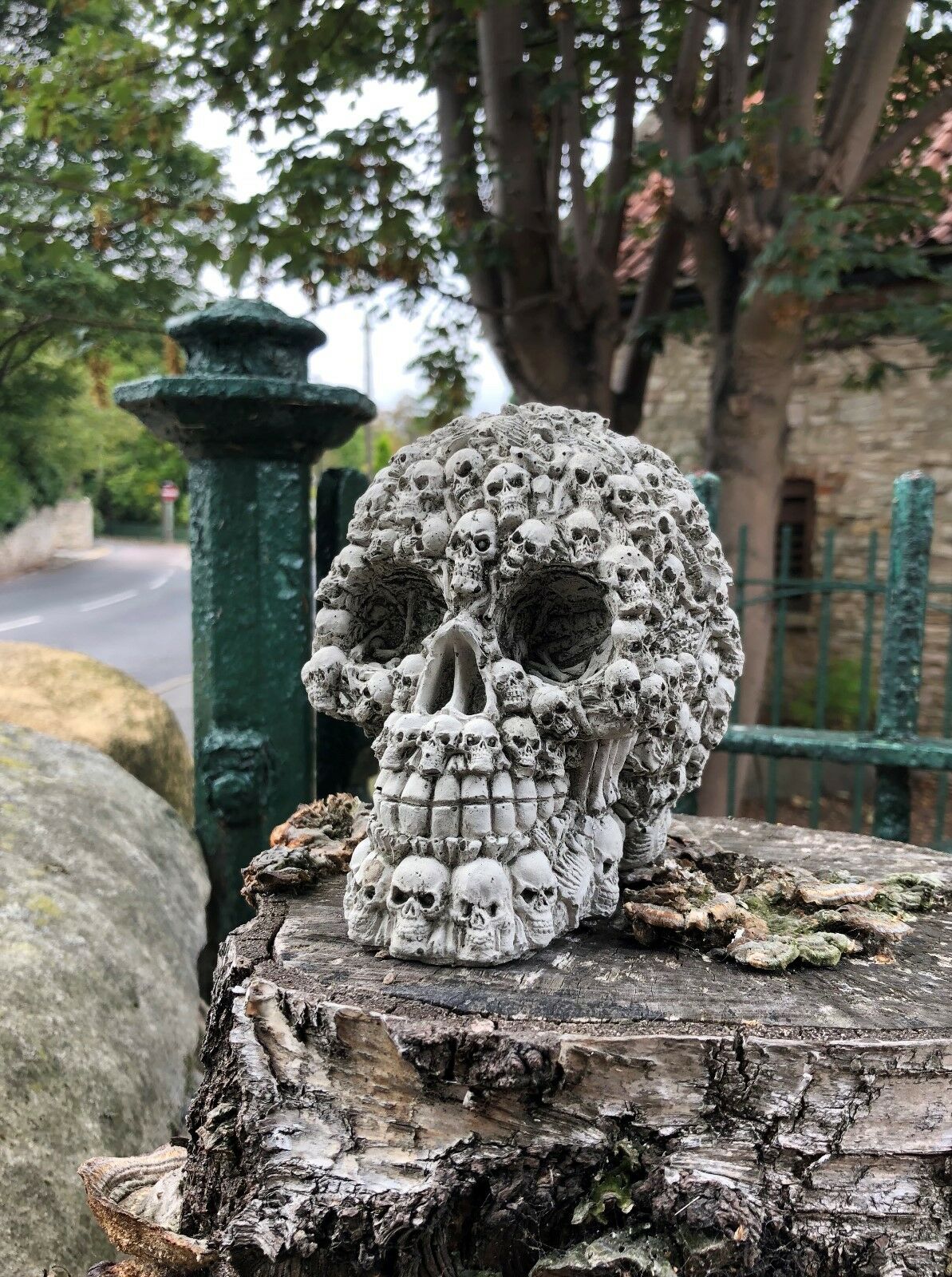 Side view of Stone Skull Garden Ornament showing detailed skull carvings. Ideal for gothic garden décor or patio sculpture display.