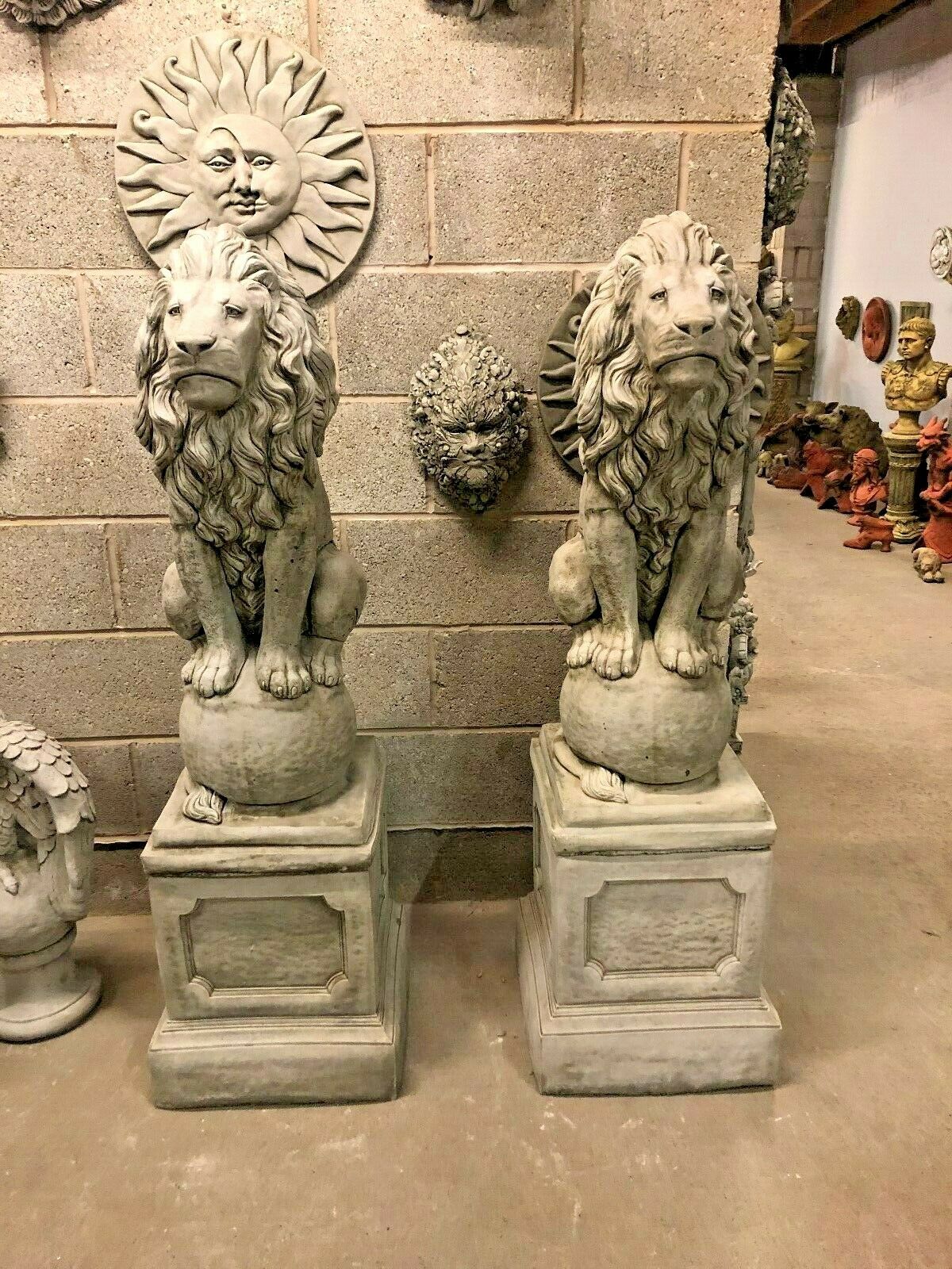 Full frontal view of a matching pair of stone lion garden statues, perfect for flanking entrances or garden pathways.