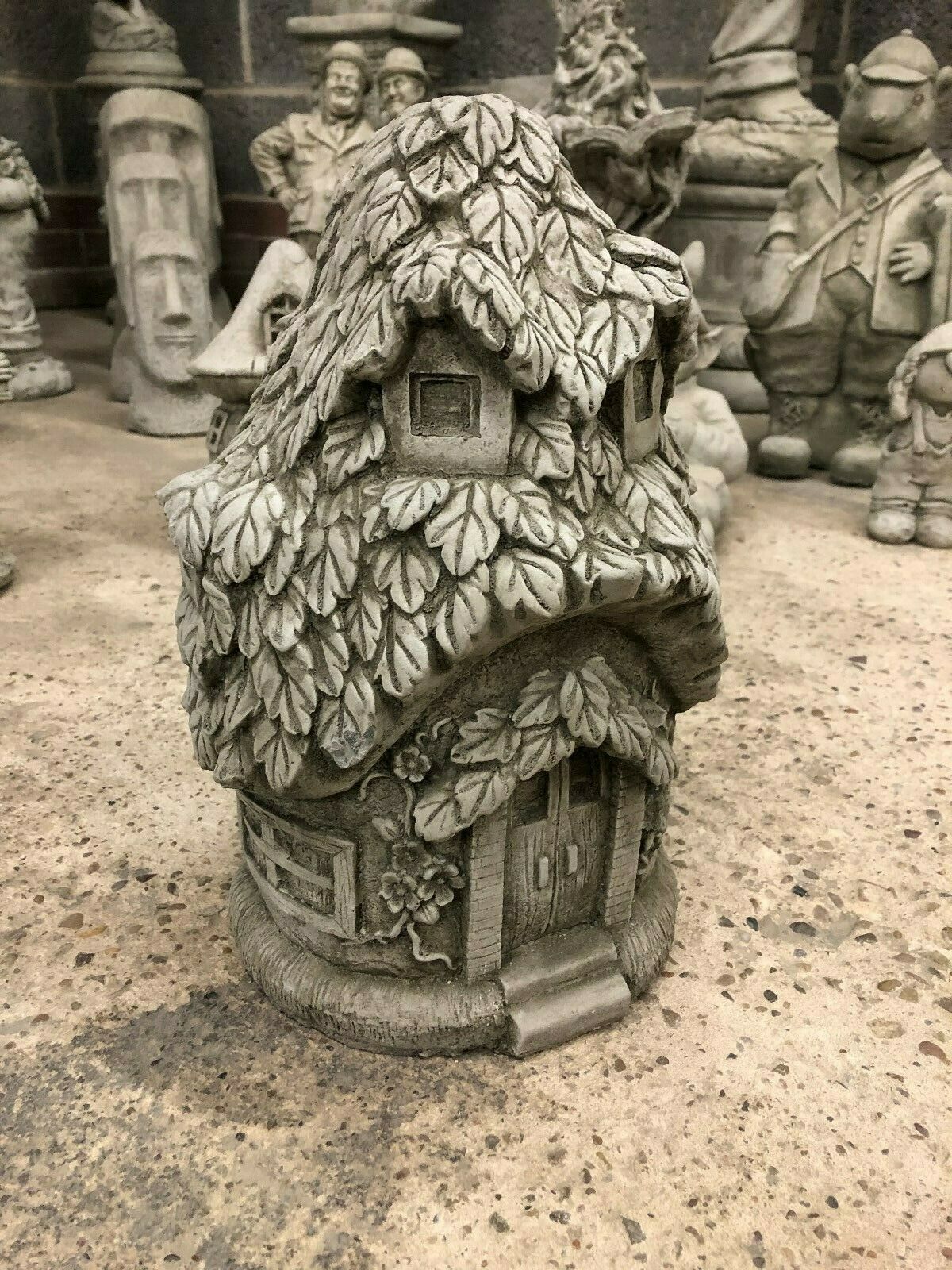 Alternate front view of Stone Ivy Cottage Ornament with visible door, ivy vines, and rustic stone craftsmanship for garden ornamentation.